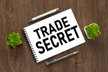 trade secrets text written on a notebook with pencils