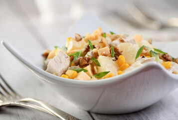 Chicken salad with pineapple, corn and cucumber dressed with Greek yogurt, crushed nuts and cheese.