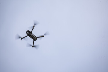 the quadcopter flies high in the sky and shoots