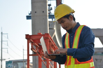 Man holding a computer in the construction 