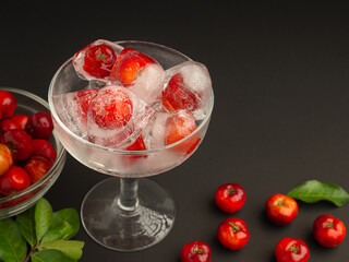 Wine glass with cherry juice on a black background