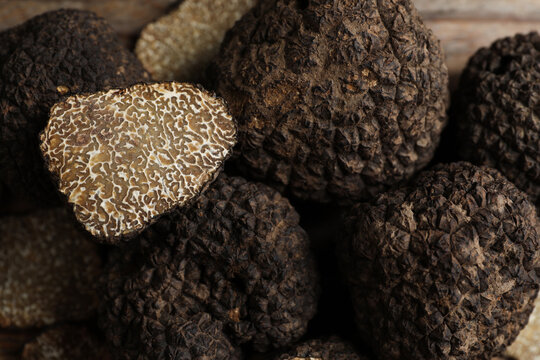 Heap of whole and cut black truffles, closeup