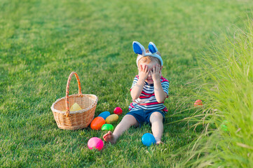 Toddler eggs hunters close-up. Children activity for Easter in nature..