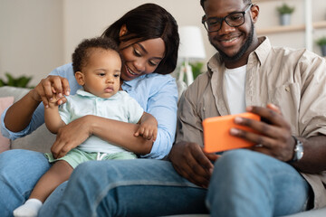 Portrait of african american family using cell phone at home