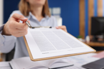 Businesswoman give silver pen to client to put signature on contract paper