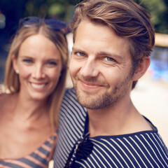 Happy together. Portrait of an attractive couple standing together and smiling.