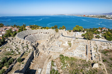 Aerial drone View Of Side Antique City . Side Old Town amphitheater. Side Harbor marina in Antalya Turkey drone photo view