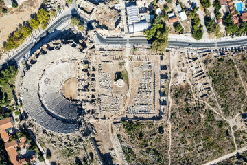 Aerial drone View Of Side Antique City . Side Old Town amphitheater. Side Harbor marina in Antalya Turkey drone photo view