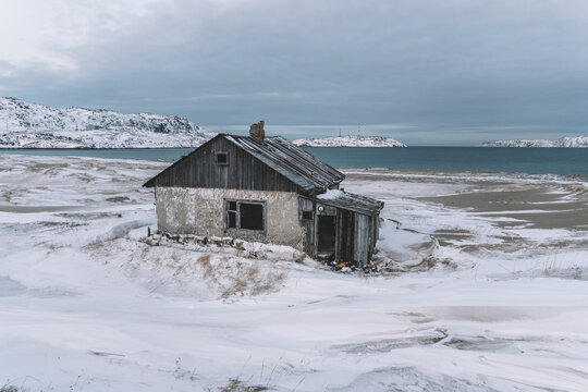 Teriberka is a village on the shore of the Arctic Ocean. The edge of the world. The far north of Russia. old fishing village on the shore of the sea. old ruined houses in winter.