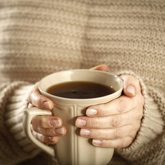 Woman hands and mug with warm drink. 