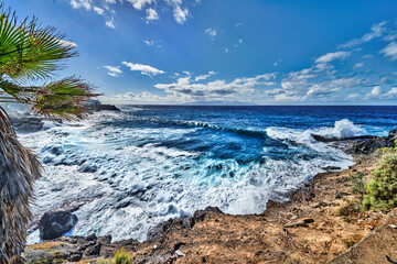 the Tenerife beach with clouds and sun , wide angle view of the sea.