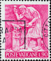 Vatican City - circa 1966: a postage stamp from Vatican City, showing a picture of a metallurgy forging an anvil
