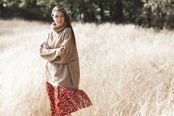 Attractive female. Young woman outdoor. Lady on neutral natural background. Cheerful girl.