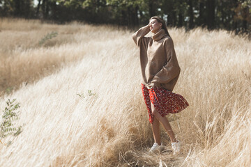 Attractive female. Young woman outdoor. Lady on neutral natural background. Cheerful girl.