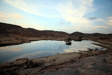 Fototapeta na wymiar A small lake in the desert with sky reflected in the water