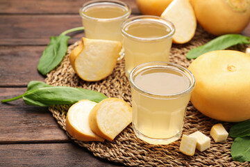 Glasses of freshly made turnip juice on wooden table