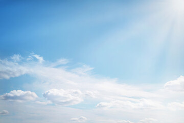 Heavenly clouds background in summer day.  Sun with beams on sky with light fluffy clouds soft focus. Heavenly clouds background in summer day. Concept of freedom, relaxation, ecology. Copy space.