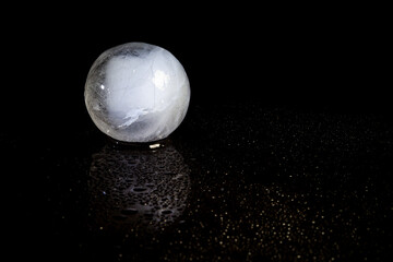 ice ball reflection on black background.