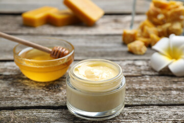Cream with natural beeswax component on wooden table, closeup