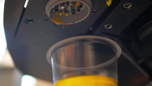 Process dosing of yellow colorant in a transparent container.