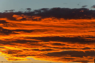 Fototapeta premium Bright orange clouds at sunset, like lava.