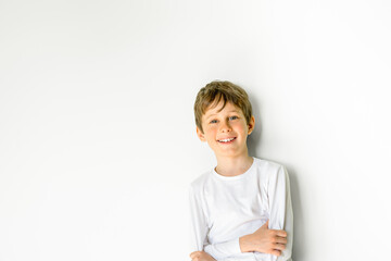 Charming boy smiles. Greeting card mockup with copy space. Portrait of a boy 8 years old, white, caucasian