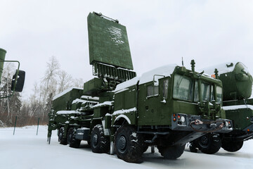 Heavy military equipment of Russian armed forces against the background of a winter forest