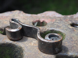 Forged metal buckle on the anvil - obrazy, fototapety, plakaty