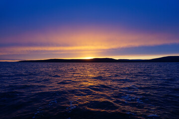 Fiery sunset over the water in the Tatar Strait