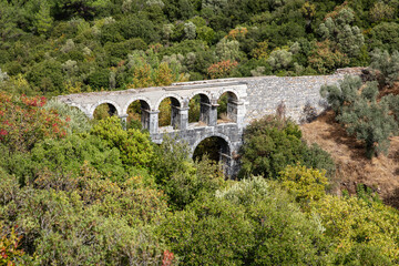 Fototapeta na wymiar Ruins of ancient Pollio aqueduct bringe in Izmir Province. Turkey
