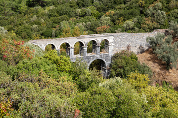 Fototapeta na wymiar Ruins of ancient Pollio aqueduct bringe in Izmir Province. Turkey