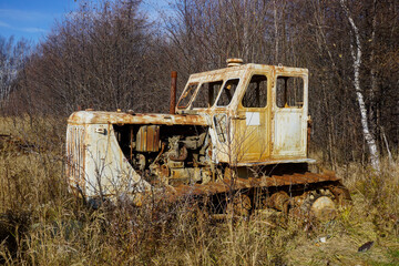 Old abandoned caterpillar tractor in the village