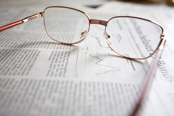 eyeglasses on the newspaper pages