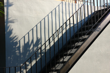 black iron stairs on cement wall