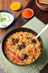 Mutton biryani Beef Biryani, Gosht or lamb biriyani Hyderabadi Dum biriyani with raita yoghurt dip special occasion Indian festival food Ramadan , Eid Hyderabad Kerala India Sri Lanka. Lankan food.