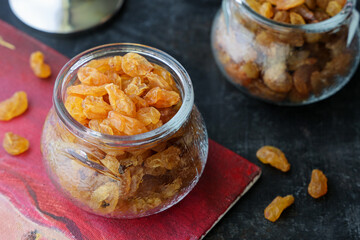 Yellow Dry raisins. Golden raisins nuts many raisins grains. Raisins in glass jar.