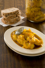 Traditional South African curry pickled snoek meal, served with freshly baked bread, is a traditional Cape Town meal, influence by the Cape Malay culture.