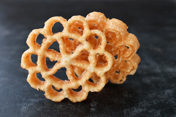 Indian fried snack Achappam Rosette Cookie is traditional popular deep fried snack at tea time...