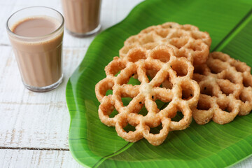 Achappam Rosette Cookie Indian milk masala tea traditional popular deep fried snack at tea time...