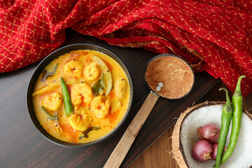 Serving prawn mango curry Chemmeen Manga shrimp in coconut milk Spicy Kerala fish curry popular Indian seafood, non veg food side dish rice, appam Goa Tamil Nadu Bengal Sri Lankan