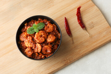 Top view spicy hot Prawn roast shrimp fry masala fish curry. Indian food fish fry red fish curry...
