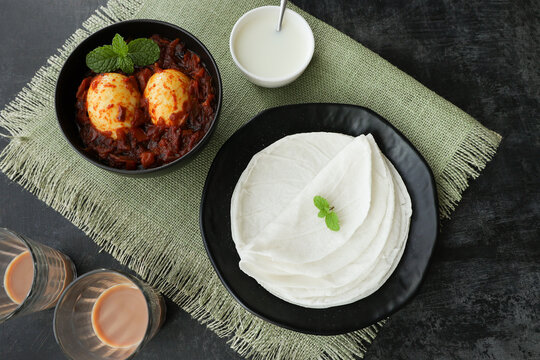 Rice Pathiri , pathir flat bread with spicy egg roast curry coconut milk Kerala India SriLanka Popular traditional South Indian breakfast dish Malabar Muslims on Ramadan Ramzan, Eid festival Rice roti