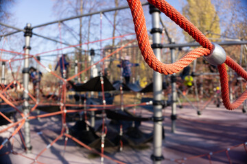 Fototapeta na wymiar Children's playground area. Rope devices for climbing. Park area in the city