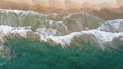 Naklejka na ściany i meble Aerial view of an emerald green sea and big foaming waves. Indian Ocean. Dikwella beach. Sri Lanka