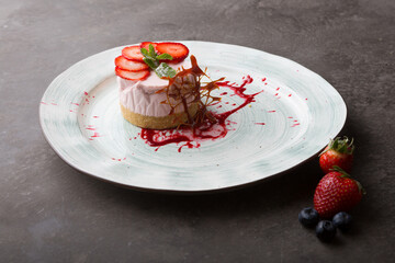 Fresh strawberry cheese cake served with berries and caramel decoration