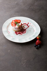 Fresh strawberry cheese cake served with berries and caramel decoration