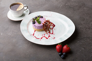 Fresh blueberry cake decorated served with cup of tea