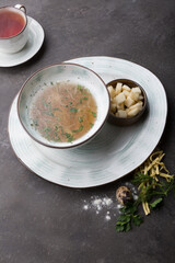 Bowl of pasta soup served with croutons and herbs