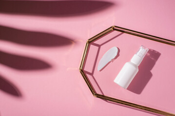 Plastic white tube for lotion with pump and the appearance of the texture of the cream in glass...