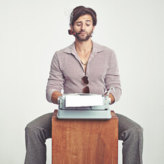 Murder He Wrote. A young man in 70s style clothing using a typewriter.